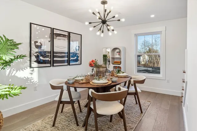 a view of a dining room with furniture window and wooden floor