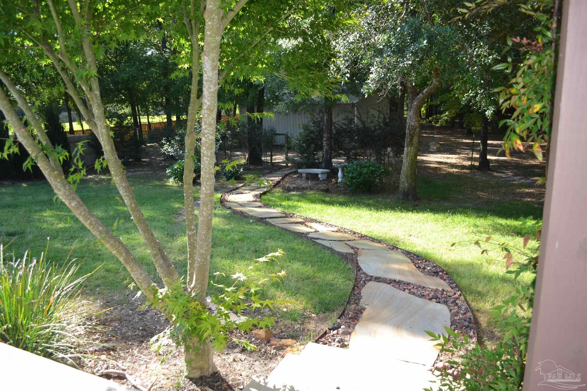 3055 Wallace Lake Road Pace, FL 32571 - Photo 9 of 33 a view of swimming pool from a garden