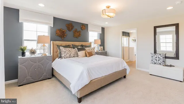 a bedroom with a large bed and a large window