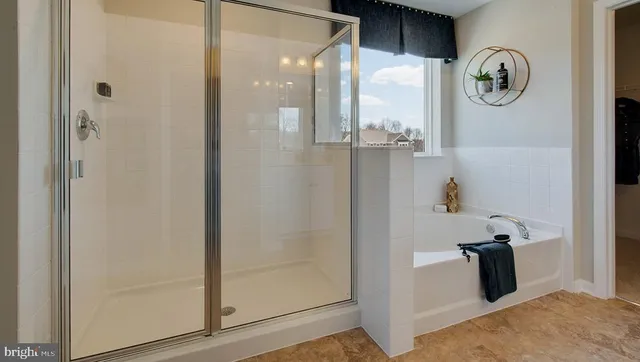 a bathroom with a shower and mirror