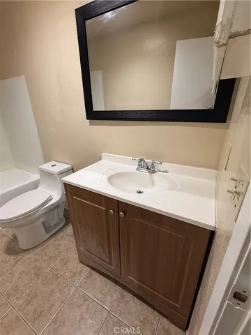 a bathroom with a toilet a sink and bathtub