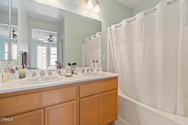 a bathroom with a double vanity sink and mirror
