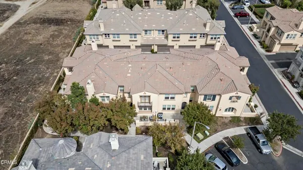 an aerial view of a house with a yard