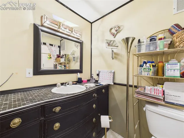 a bathroom with a sink a toilet and a shower curtain