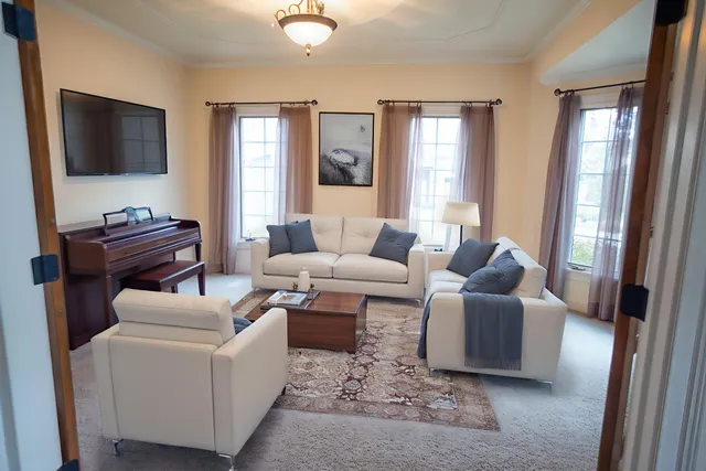 a view of a livingroom with furniture window and wooden floor
