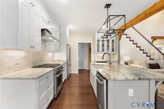 a kitchen with sink stove and cabinets