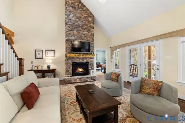 a living room with furniture large window and a fireplace