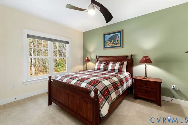 a large bed sitting in a bedroom next to a window