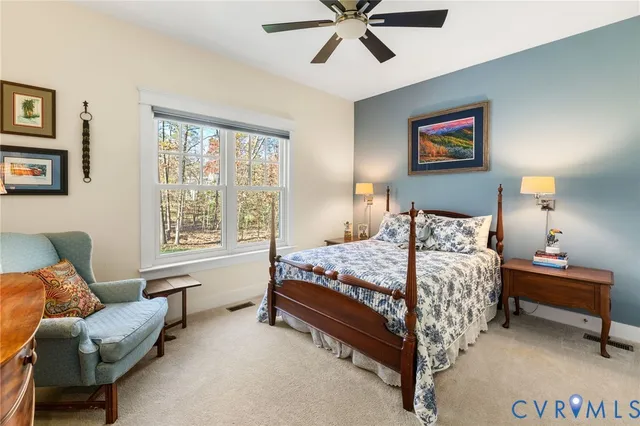 a bedroom with a bed couch and window