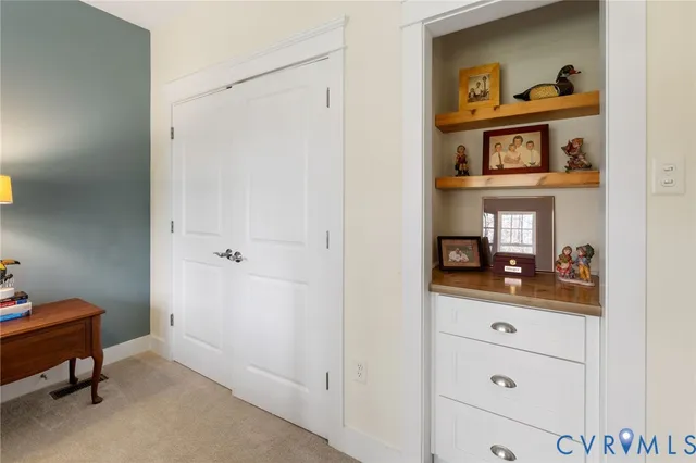 a room that has a dresser and a bed in it