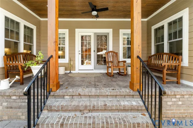 a view of front door of house with wooden floor and furniture