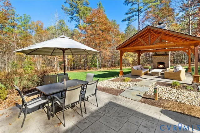a view of a table and chairs under an umbrella