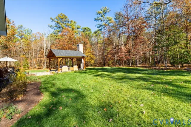 a view of backyard of house with green space