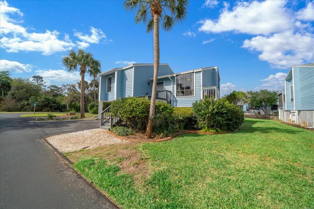 2925 North Rivers Edge Boulevard, Unit 2925 Crystal River, FL 34429 - Photo 27 of 79 a front view of a house with yard and tree s
