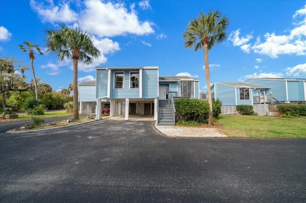 2925 North Rivers Edge Boulevard, Unit 2925 Crystal River, FL 34429 - Photo 28 of 79 a view of a house with a yard and palm trees