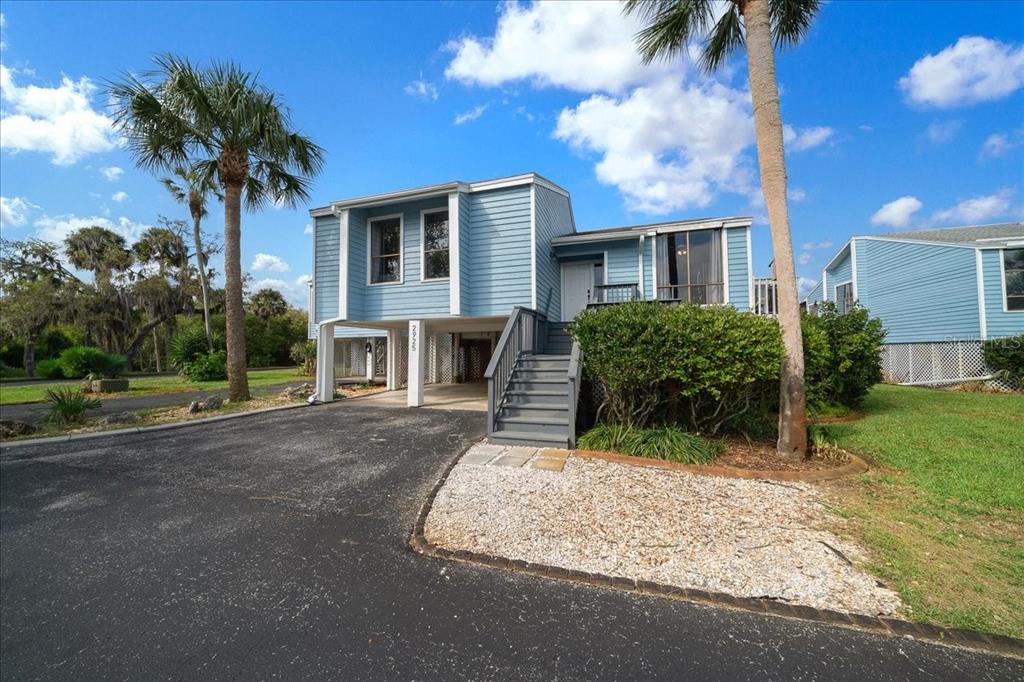 2925 North Rivers Edge Boulevard, Unit 2925 Crystal River, FL 34429 - Photo 30 of 79 a front view of a house with a yard and a garage
