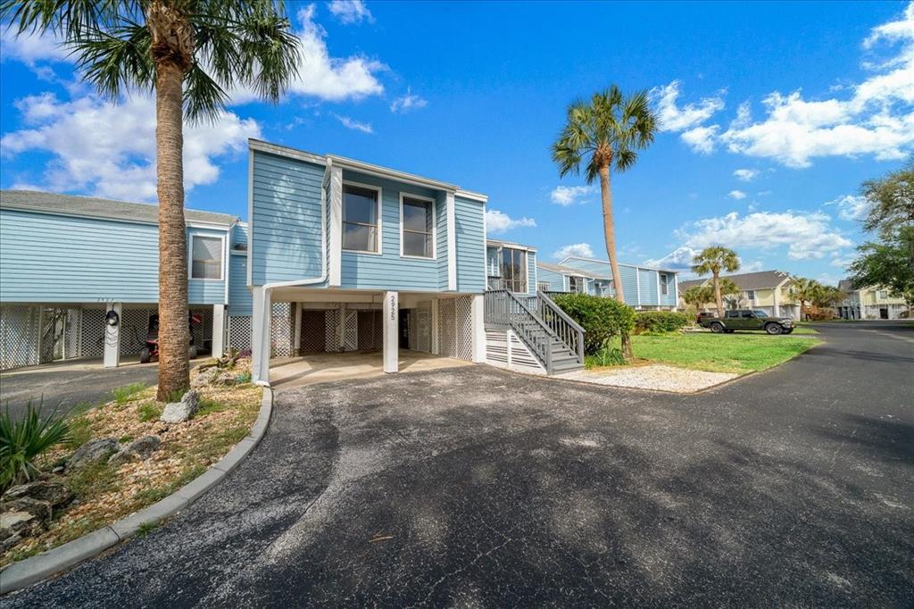 2925 North Rivers Edge Boulevard, Unit 2925 Crystal River, FL 34429 - Photo 31 of 79 a front view of a house with a yard and garage