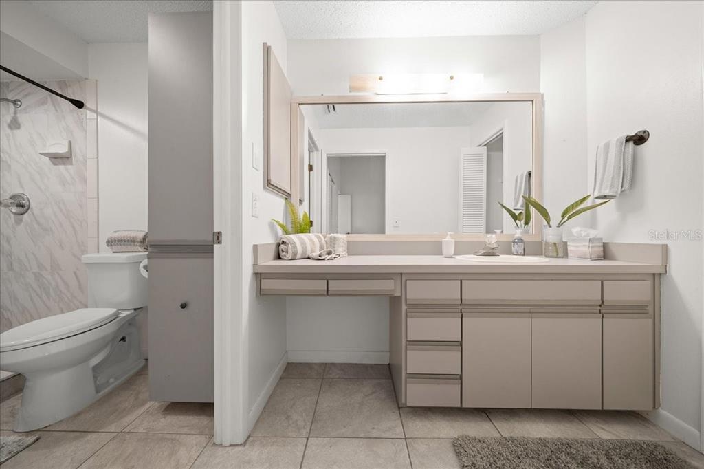 2925 North Rivers Edge Boulevard, Unit 2925 Crystal River, FL 34429 - Photo 6 of 79 a bathroom with a granite countertop sink a toilet and a mirror