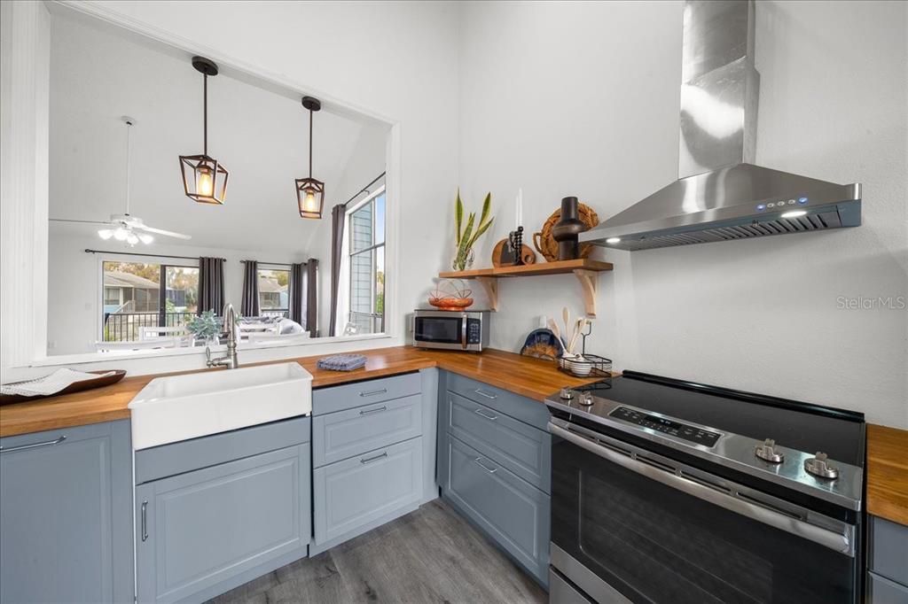2925 North Rivers Edge Boulevard, Unit 2925 Crystal River, FL 34429 - Photo 64 of 79 a kitchen with a sink a stove and cabinets