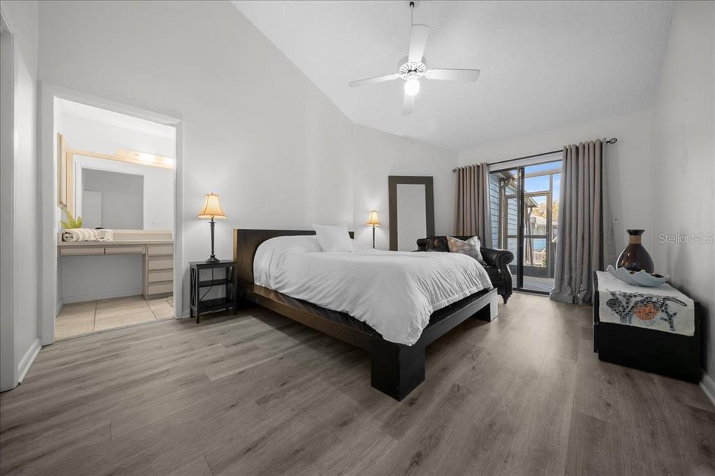 2925 North Rivers Edge Boulevard, Unit 2925 Crystal River, FL 34429 - Photo 77 of 79 a bedroom with a bed and a chandelier