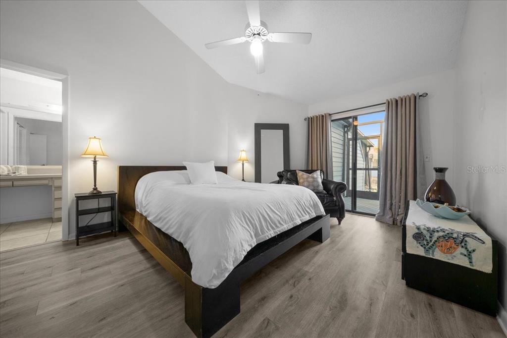 2925 North Rivers Edge Boulevard, Unit 2925 Crystal River, FL 34429 - Photo 78 of 79 a bedroom with a bed and wooden floor
