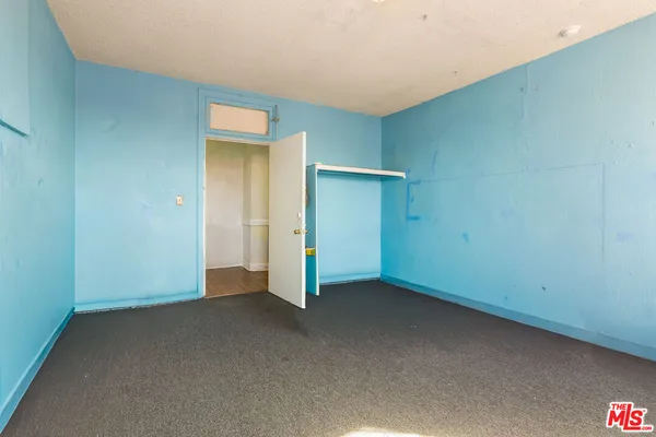 a view of an empty room with closet