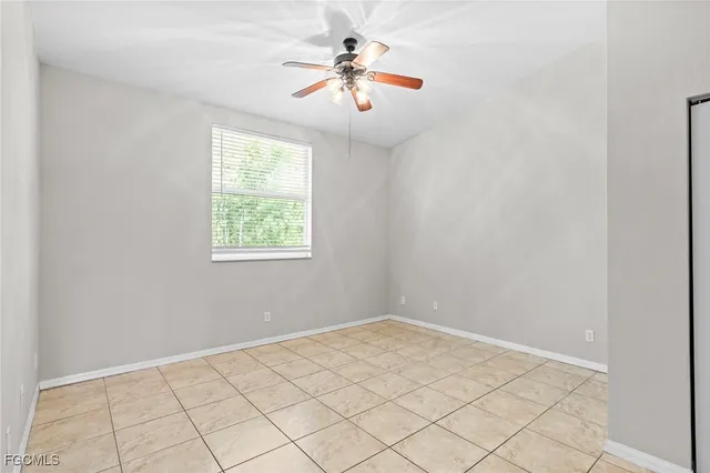 a view of a room with window and ceiling fan