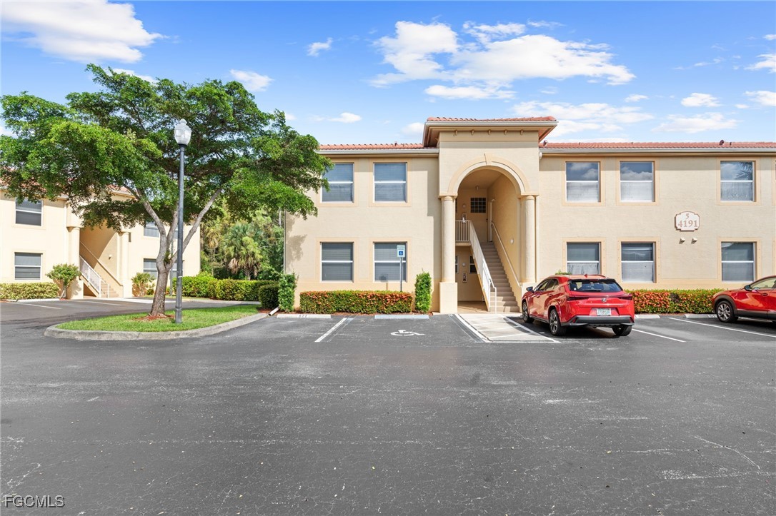 4191 Bellasol Circle, Unit 521 Fort Myers, FL 33916 - Photo 20 of 22 a view of a car park in front of a building
