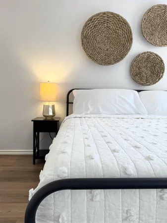 a bedroom with a bed and a painting on the wall
