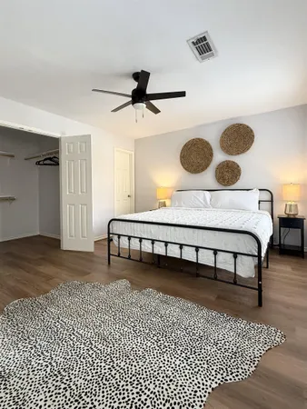 a view of a bedroom with wooden floor