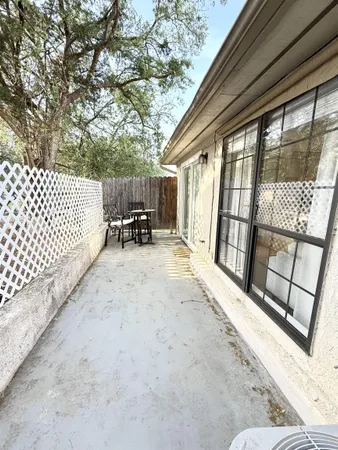 a bathroom with a bathtub shower sink vanity mirror and toilet
