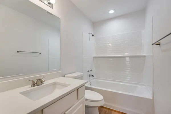 a bathroom with a sink a toilet and mirror