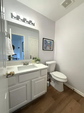 a bathroom with a toilet sink and mirror