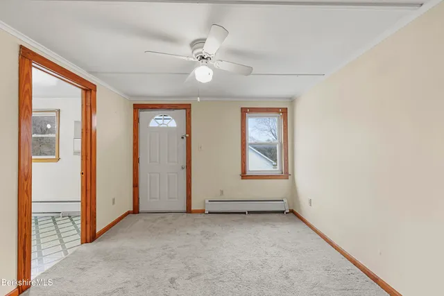 an empty room with closet and a ceiling fan