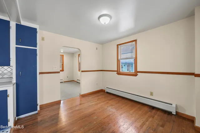 a kitchen with stainless steel appliances kitchen island granite countertop a refrigerator and a stove top oven