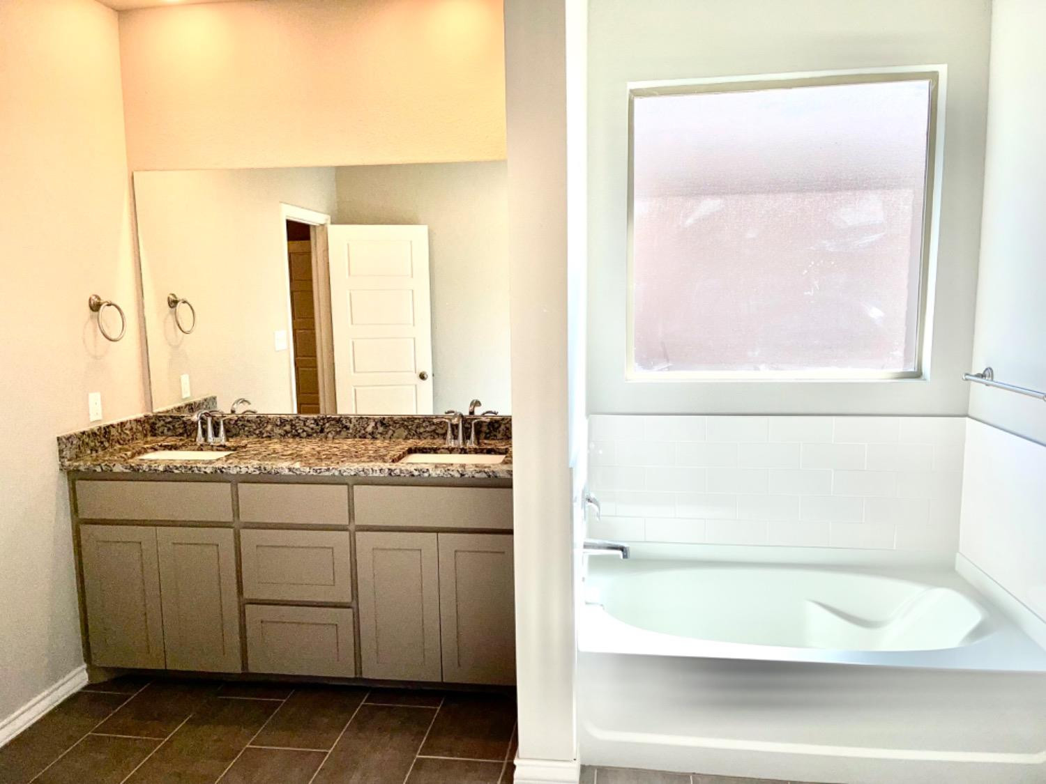 7729 96th Street Lubbock, TX 79424 - Photo 15 of 35 a bathroom with a granite countertop sink and a mirror