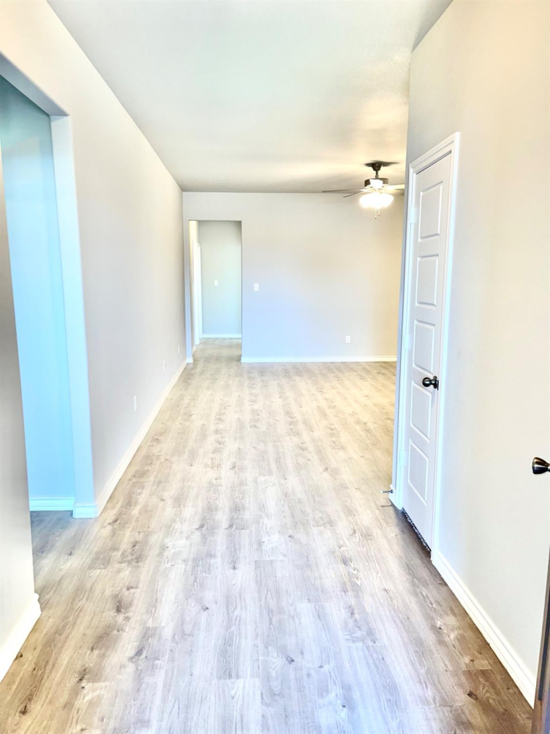 7729 96th Street Lubbock, TX 79424 - Photo 3 of 35 a view of an empty room with wooden floor and a window