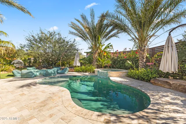 a view of a patio with couches chairs and a umbrella