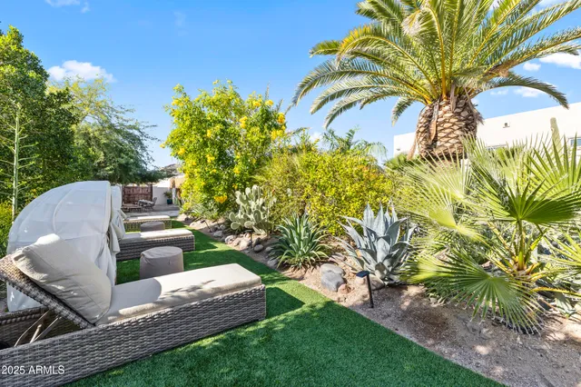 a backyard of a house with table and chairs