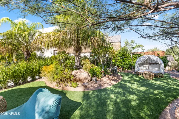 a backyard of a house with table and chairs