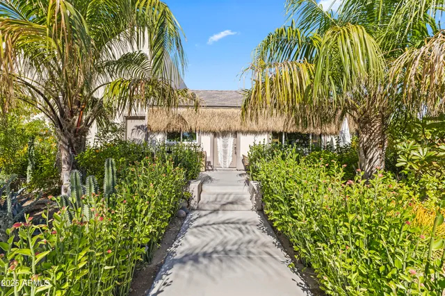 a backyard of a house with table and chairs
