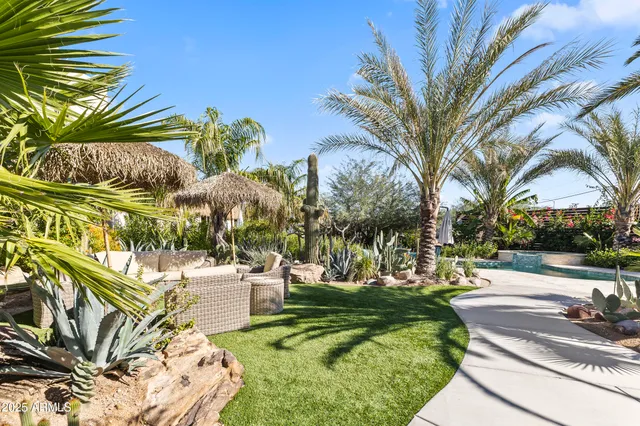 a backyard of a house with table and chairs