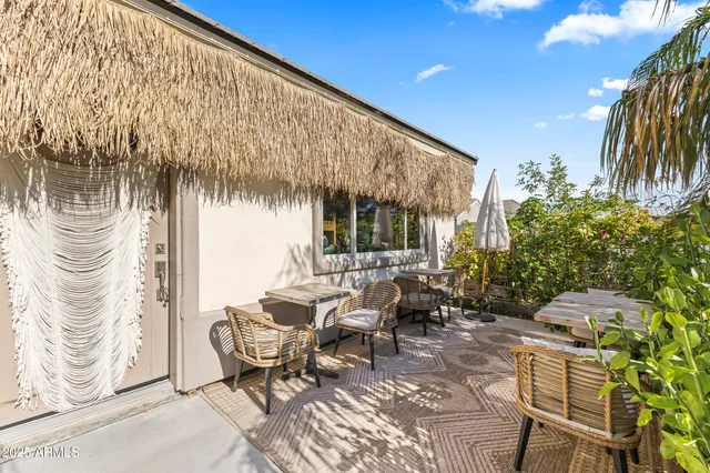 a view of a patio with table and chairs and potted plants