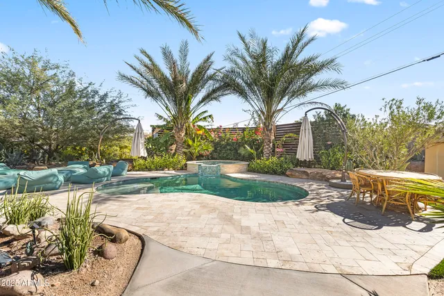 a view of a backyard with a patio and outdoor seating