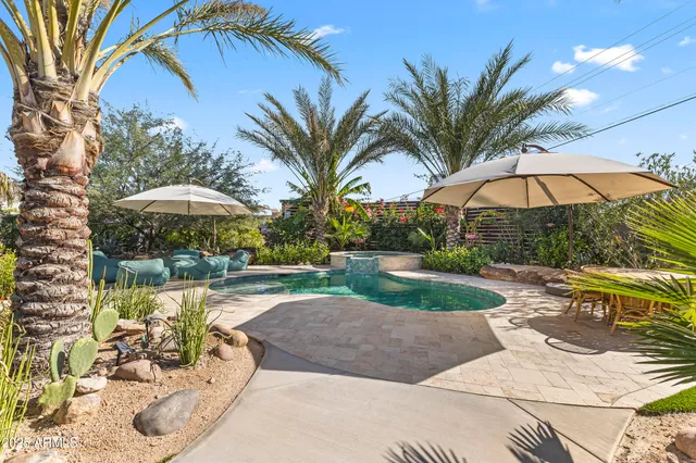 a view of a backyard with a patio and outdoor seating
