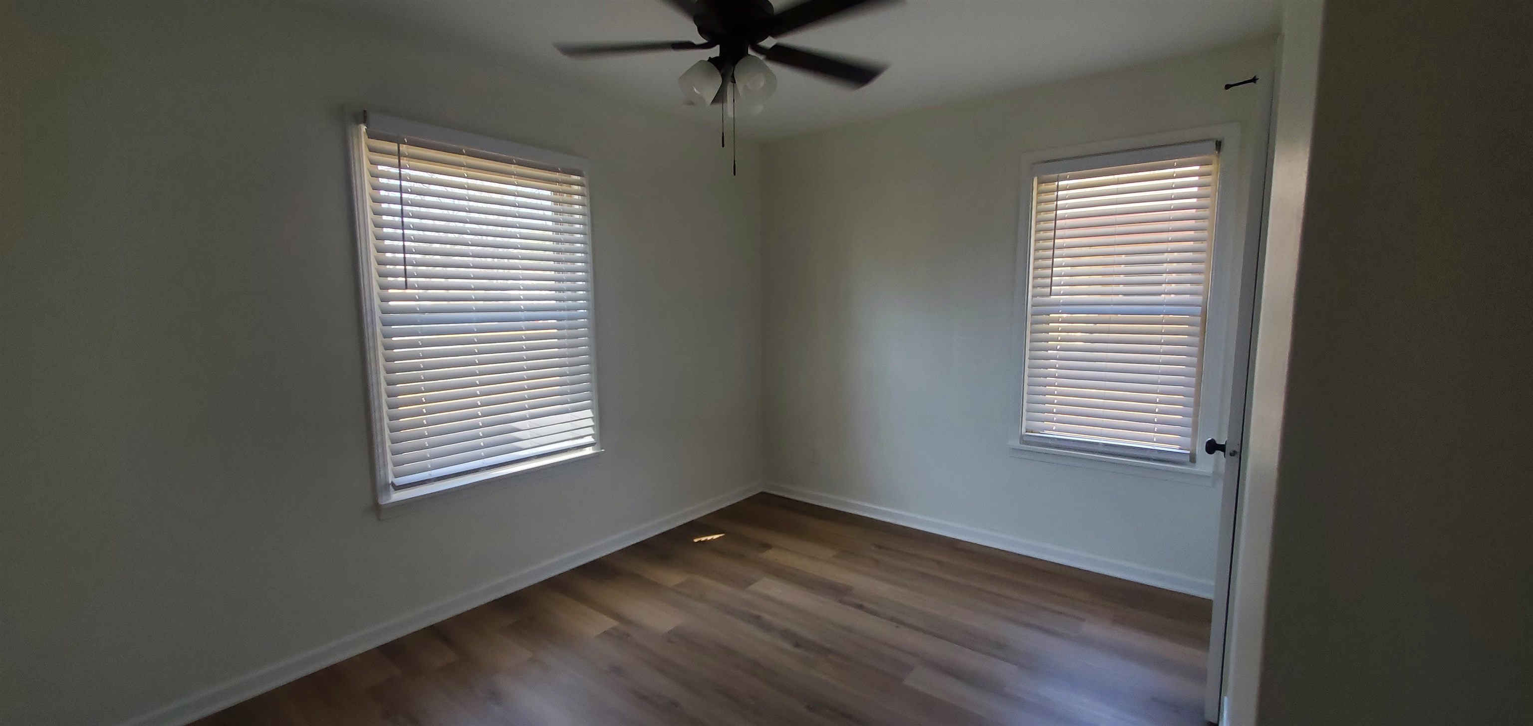 5352 Virgil Road Bartlett, TN 38134 - Photo 12 of 21 an empty room with wooden floor and windows