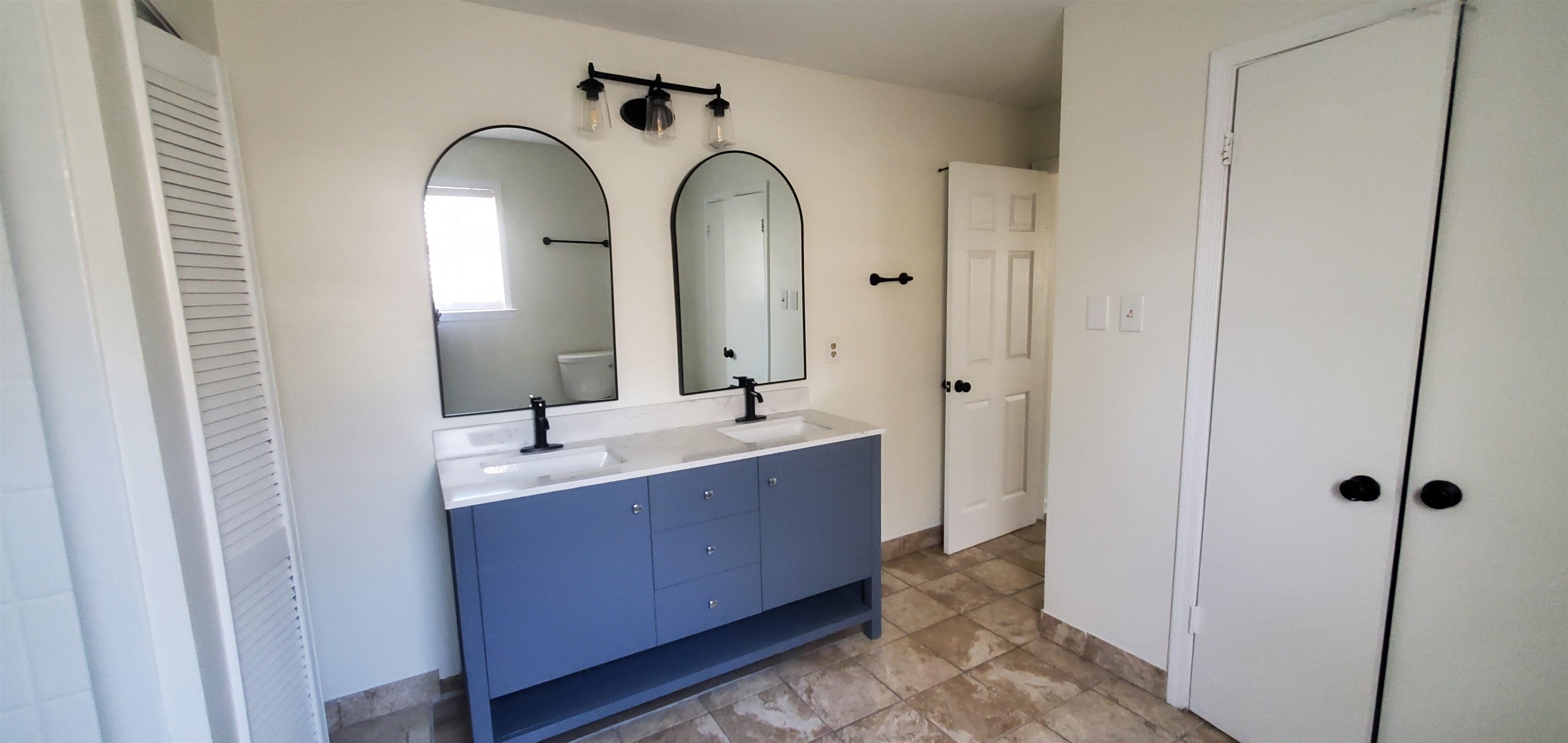 5352 Virgil Road Bartlett, TN 38134 - Photo 17 of 21 a bathroom with a double vanity sink and a mirror