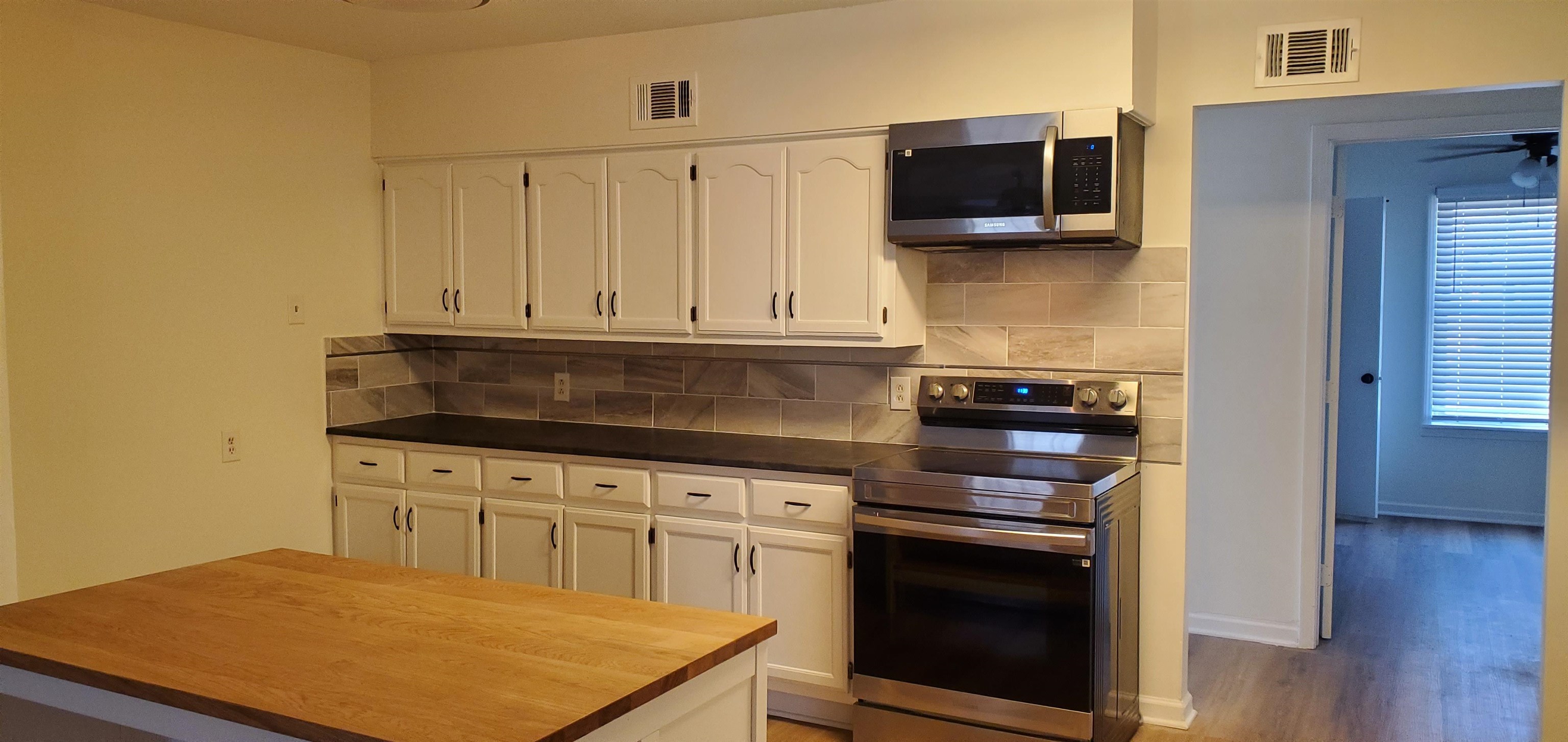 5352 Virgil Road Bartlett, TN 38134 - Photo 5 of 21 a kitchen with stainless steel appliances granite countertop a stove a sink and a microwave