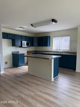 a kitchen with stainless steel appliances granite countertop a sink and cabinets