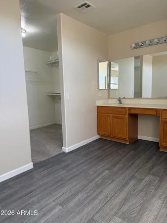 a view of a kitchen with wooden floor and staircase